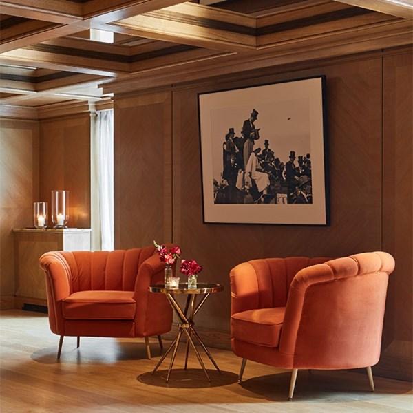 Two chairs facing one another in a panelled room