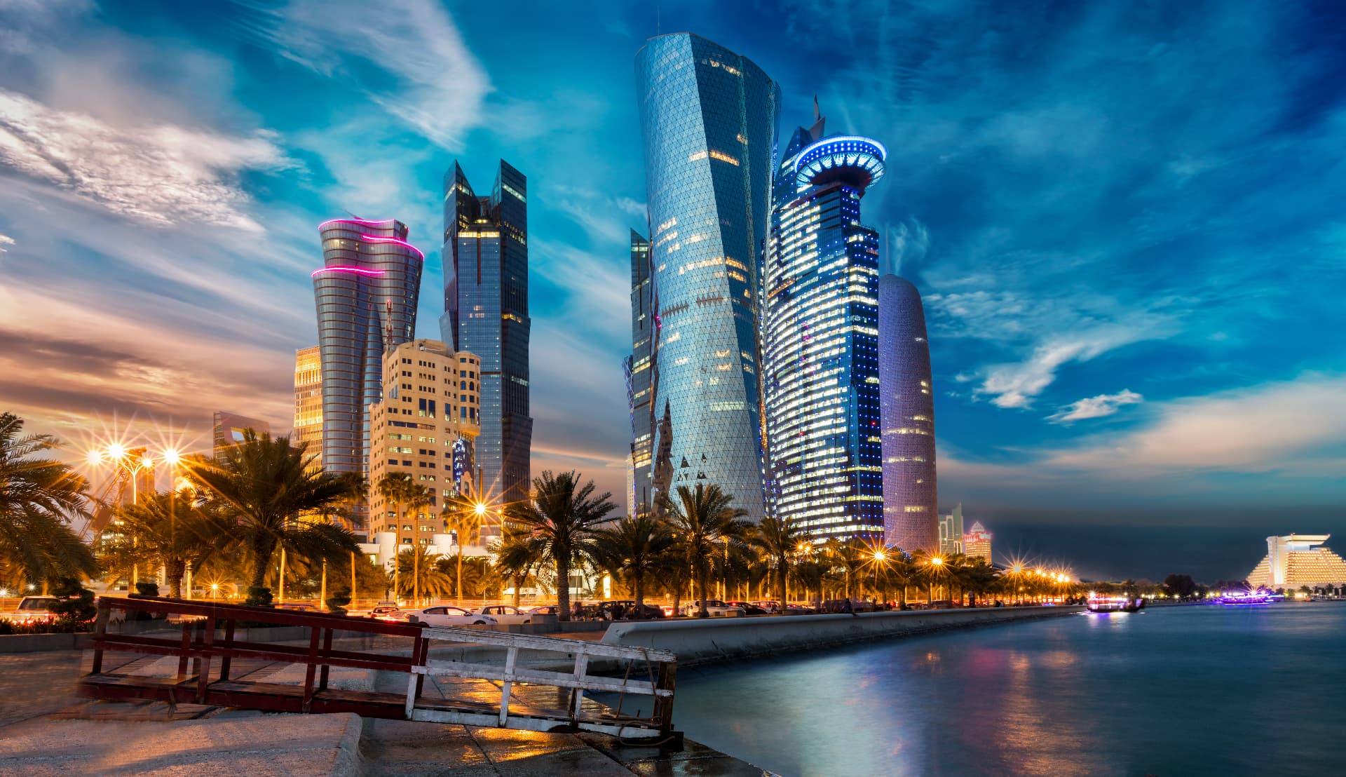 Doha's West Bay skyline beside the Corniche at dusk