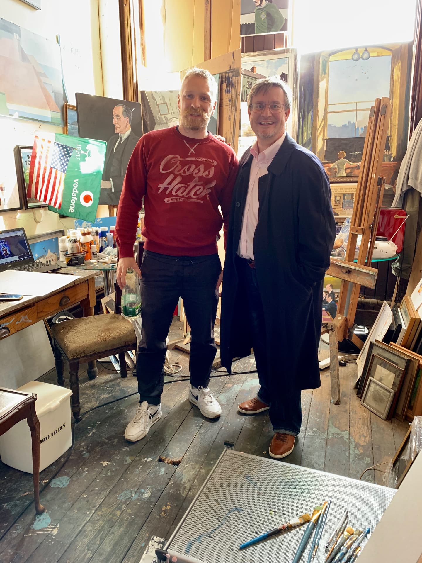 Brian John Spencer (left) and Mark J. Finlay in Brian’s Belfast studio, surrounded by paintings and easels.