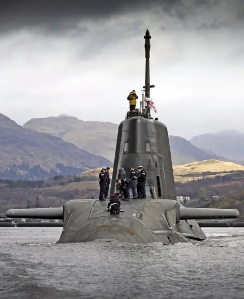 A Royal Navy submarine amid Highland hills on the Clyde approaches